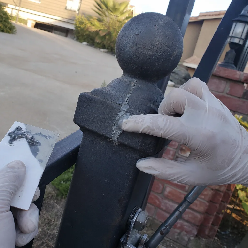 Repairing a cracked metal gate post finial with epoxy filler